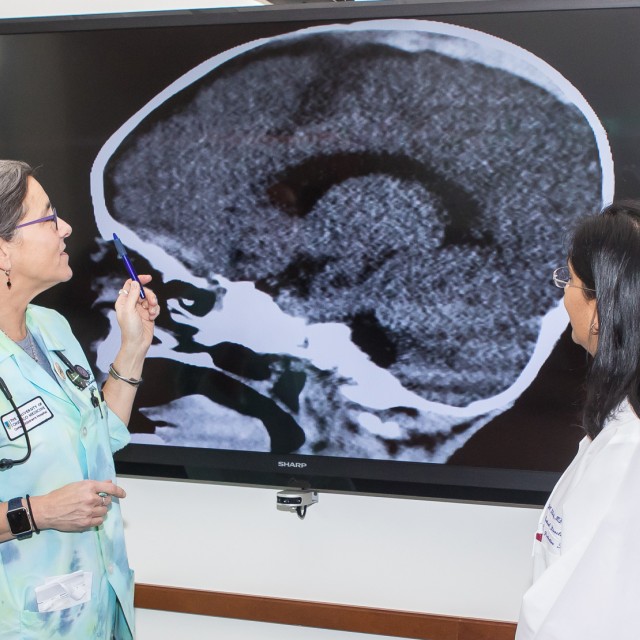 Jill C. Glick, MD, and Veena Ramaiah, MD, look at a brain scan