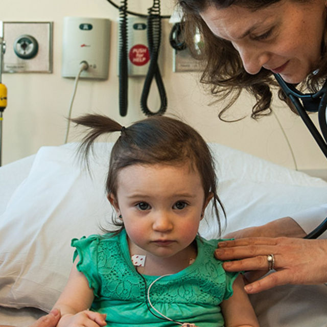 Doctor checks young patient with a stethoscope 