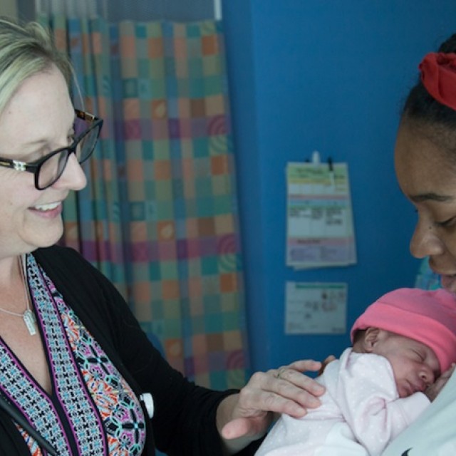 Preemie with her mother and doctor in the NICU