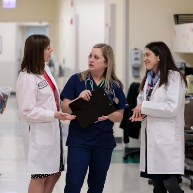 Medical providers talk in hallway