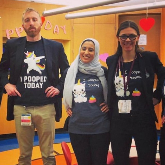 GI team wearing matching shirts with a unicorn dancing with text that says I pooped today