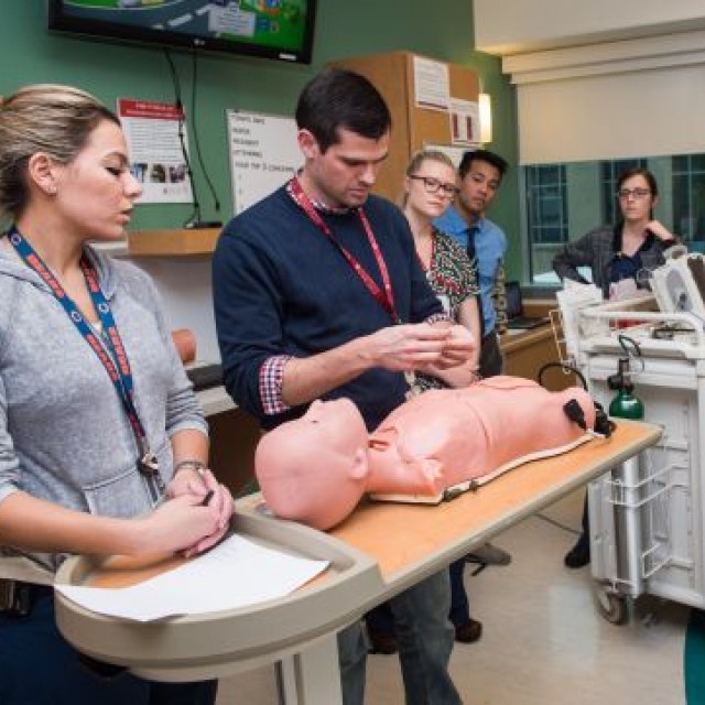 Medical providers practice CPR in a simulation center
